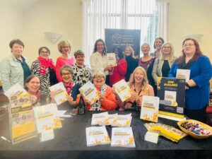 members of WBN holding up their WBN collaborative book copies