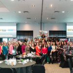 80 women in business in front of the stage at Great Women in Business Event