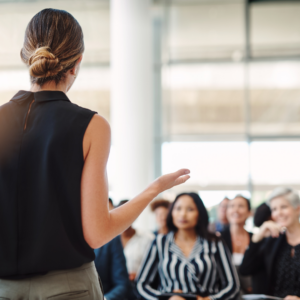 Woman standing presenting to a group of women