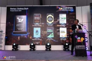 Big screen displaying 6 finalists book covers in Start Up Scale up category on Awards event stage