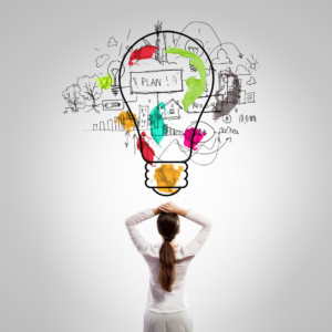 picture of the bag of a woman with her hands on her head looking at a graphic of a lighbulb with flashes of colour and the words plan, money and graffiti style drawings