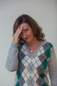 lady with her hand hiding part of her face as she is shy