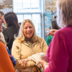 3 ladies chatting and laughing at a networking event