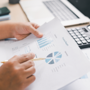 Financial report in soft focus on a desk with laptop and calculator 