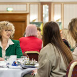 ladies sat chatting at networking event