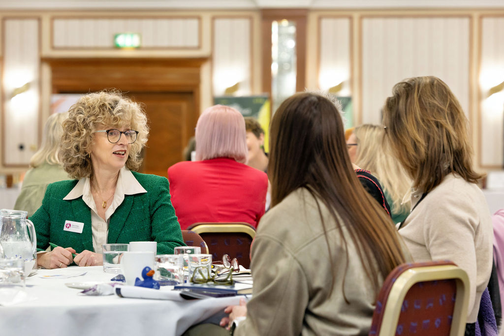 ladies sat chatting at networking event